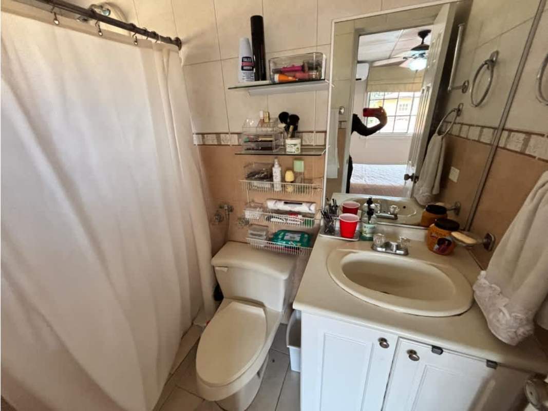 Dining room area with glass-top table, wood chairs, window blinds in Dorado Lake Condado del Rey furnished house rental