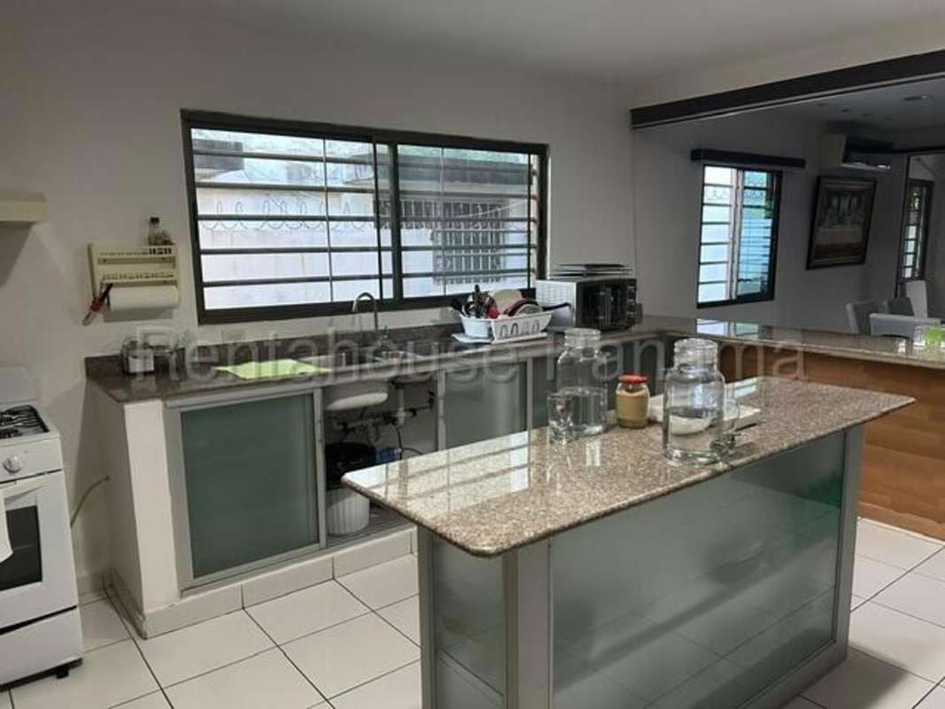 Modern bathroom with walk-in shower and tiled walls family house Chanis Panama