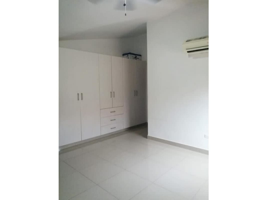 Functional modern kitchen with wood cabinets and tile floor Green Village Panama