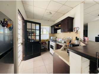 Traditional kitchen with tile counters and wood cabinets in Chiriquí house