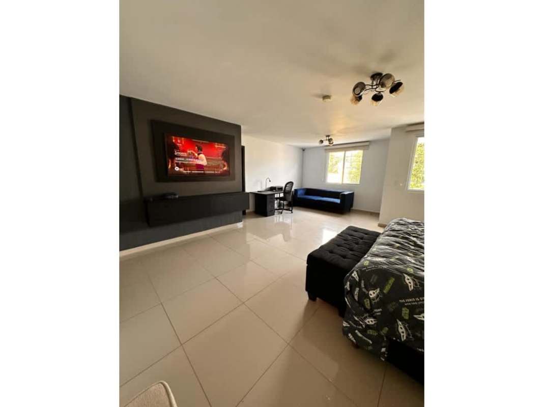 Bright kitchen with wood cabinets, tile floor, natural light and appliances in El Doral Altos del Bosque