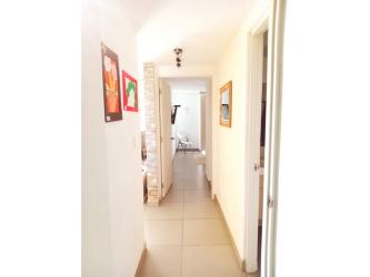 Small wooden gate with greenery outside Punta Barco apartment complex