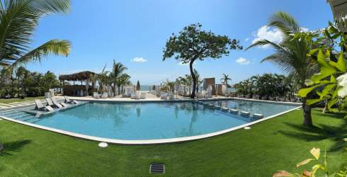 Resort pool with palm trees, ocean views Playa Caracol Punta Chame Panama