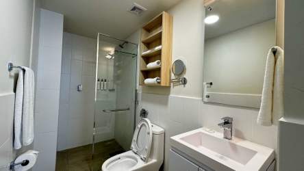Minimalist bathroom with glass shower modern fixtures Playa Caracol condos Panama