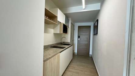 Modern compact kitchen with granite countertop Playa Caracol condos Panama