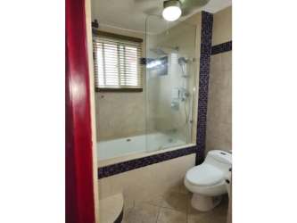 Bathroom featuring bathtub with glass enclosure Vista Mar condo San Carlos Panama