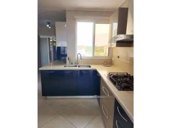 Kitchen with navy blue cabinetry, stainless steel stove and hood, modern style Vista Mar Panama