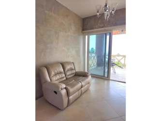 Bright kitchen with gas cooktop and white cabinetry in Vista Mar condo Panama