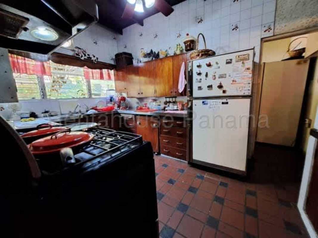 Large covered terrace overlooking lush garden at Betania Residence for sale in Panama