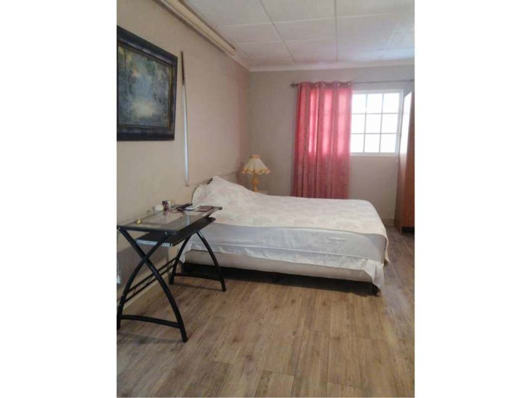 Spacious master bedroom with light tile floor, fan, closet space in Villa Zaita Panama