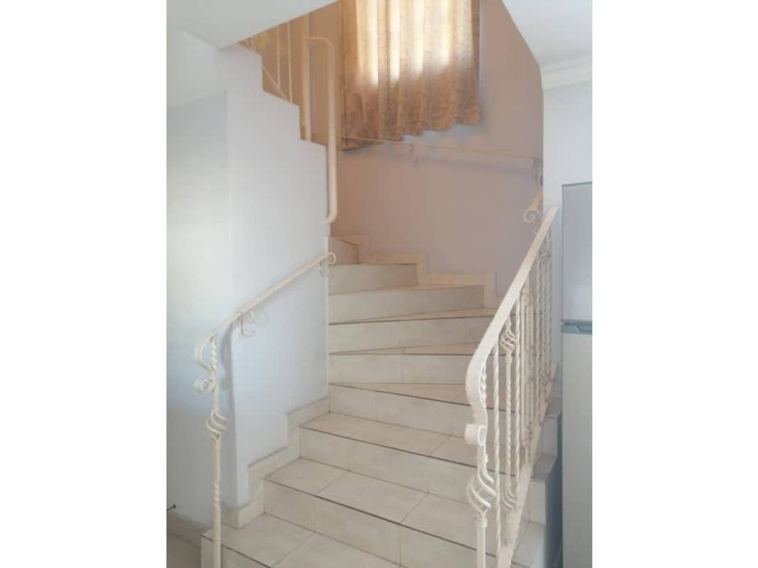 Functional kitchen space with tiled backsplash, cabinets and gas stove in Villa Zaita Panama