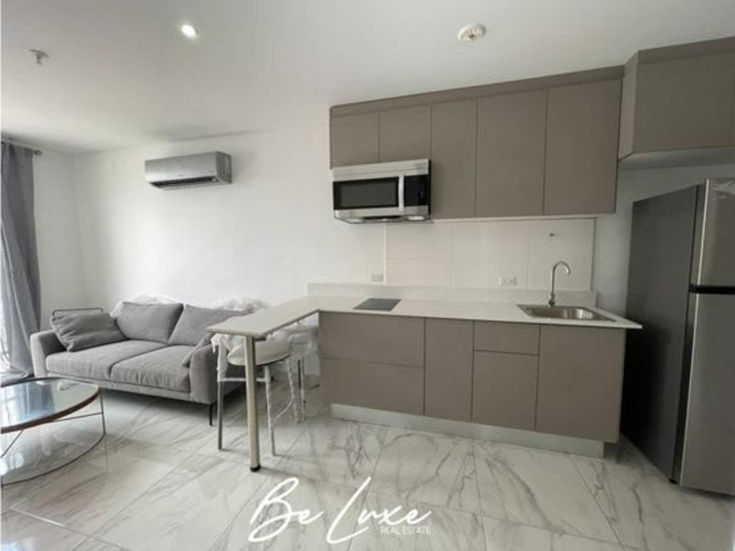 Modern fitness center with equipment and city views in PH The Gray Panama City