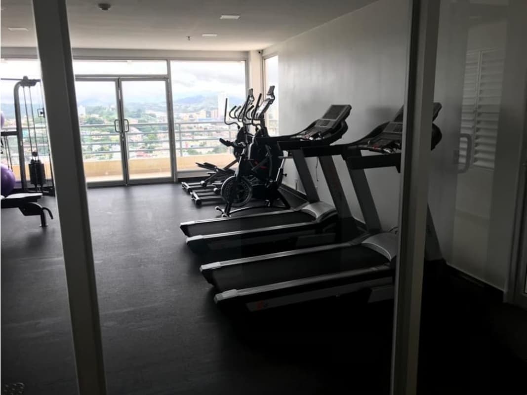 Modern fitness center with cardio and weight equipment city view PH Macedonia Tower Panama