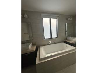 Modern bathroom with glass shower and granite vanity PH Nativa Panama Pacifico