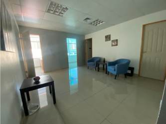 Bright waiting area with blue chairs in commercial office space Plaza Korintho Panama City