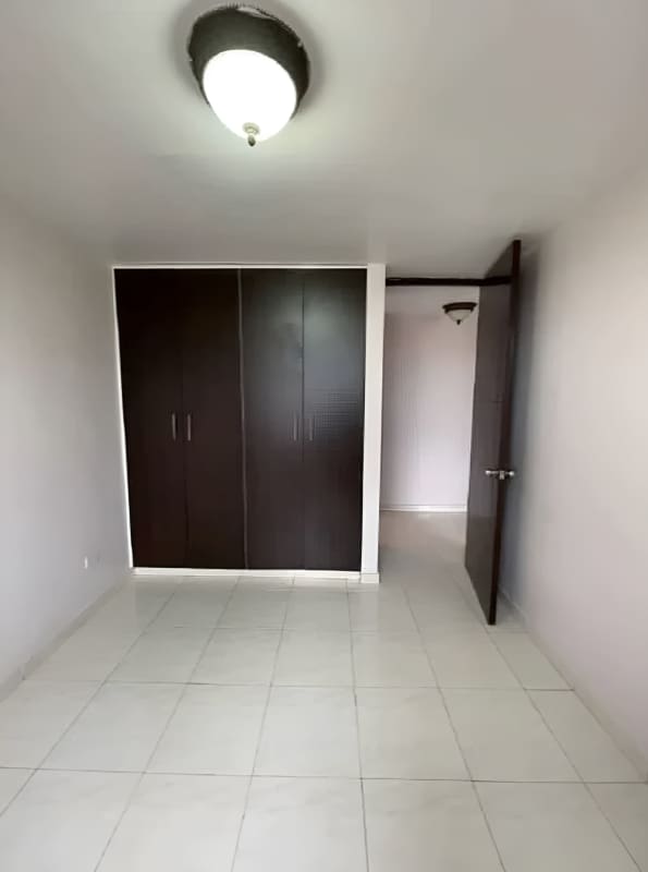 Bedroom with built-in closet, neutral walls, tile floors at PH Villa de las Fuentes Panama