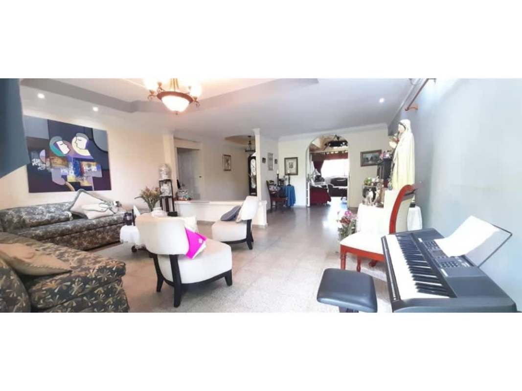 Covered patio overlooking tropical backyard garden in Panama house for sale