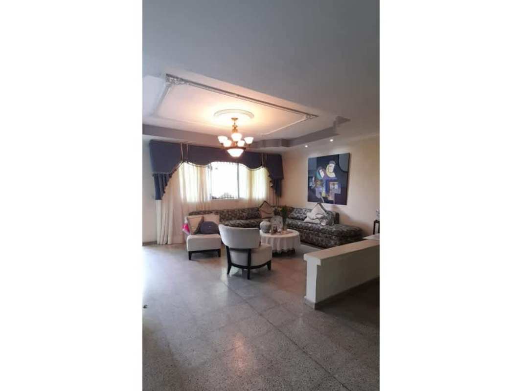 Kitchen with wood cabinetry, large windows, and dining corner in house for sale Panama City