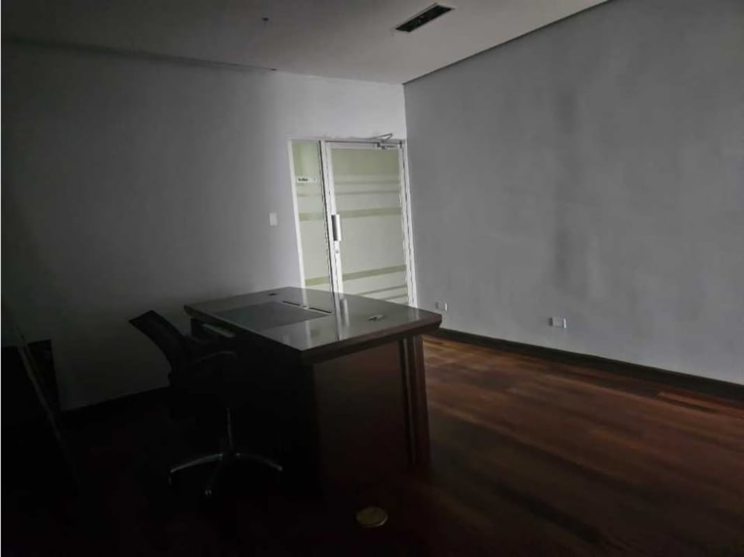 Glass enclosed private offices with wooden floors overlooking Panama skyline Calle 50