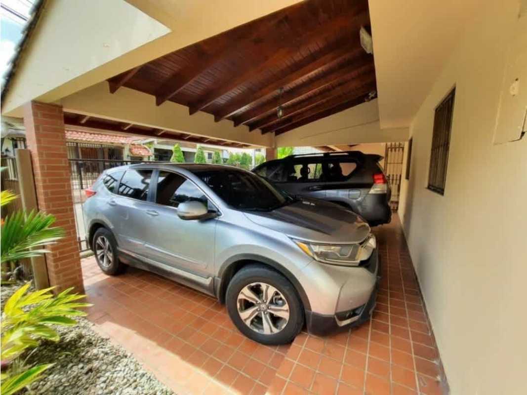Bright main living area with big windows, garden view, traditional flooring in La Alameda Panama