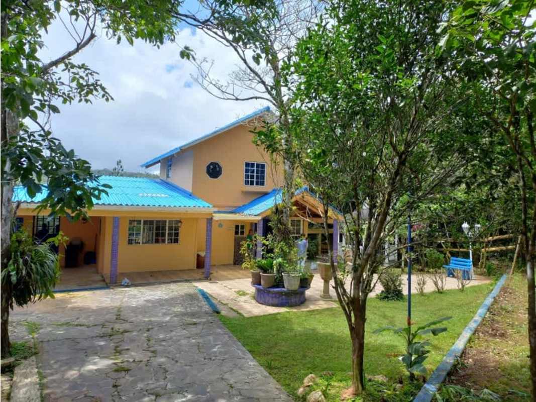 Rustic countryside house with blue roof, garden and trees in Cerro Azul Panama