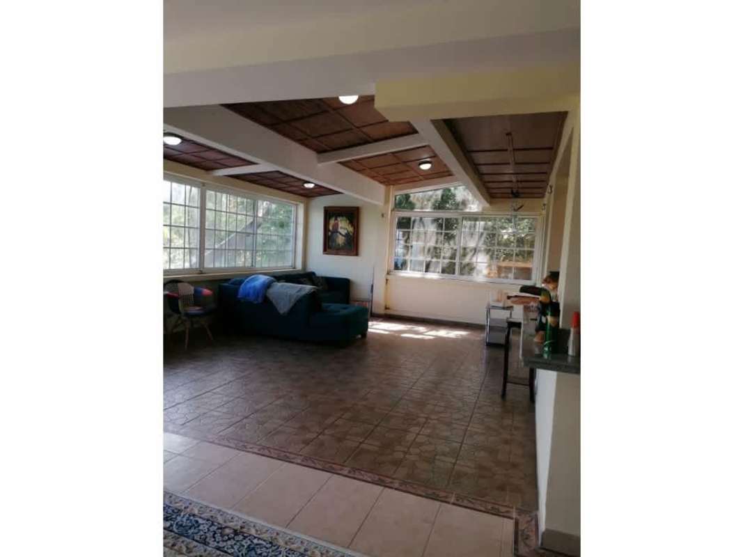 Living area with large windows, natural light, and wood accents in Cerro Azul Panama