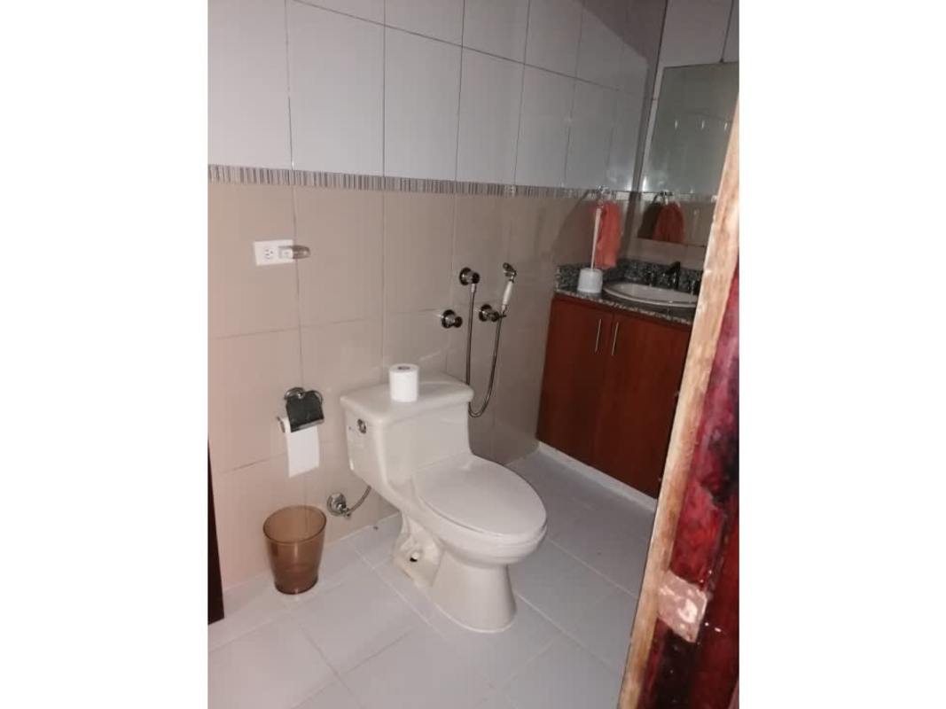 Modern bathroom with granite countertop, tiled walls, glass shower in Cerro Azul Panama