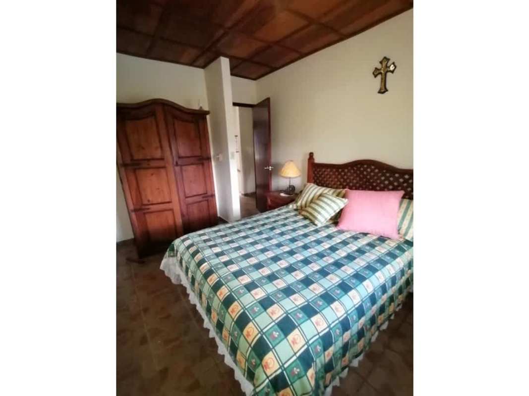 Bedroom with dark wood furnishings and ceiling, cozy mountain retreat Panama