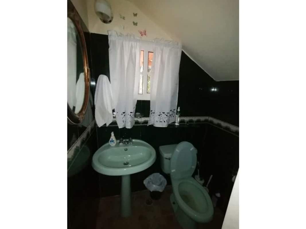 Rustic bathroom with green sink and decorative wall tiles, Cerro Azul Panama