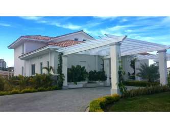 Open living and dining area with floating wooden staircase Casamar San Carlos Panama