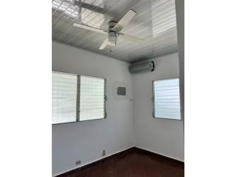Bedroom with louvered windows, ceiling fan and AC in Punta Barco beach house