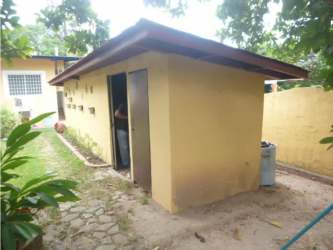 Small yellow outbuilding with garden at Punta Barco beach property