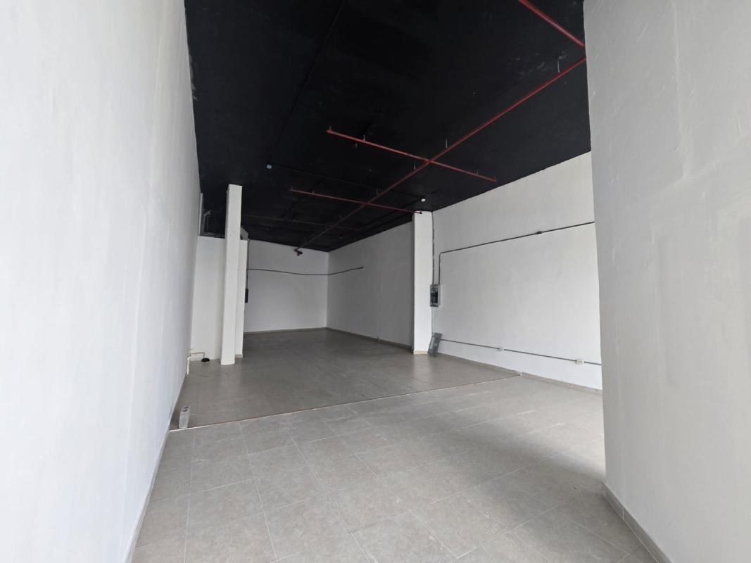 Spacious commercial unit with high industrial ceiling, grey tiled floors, white walls, Panama City
