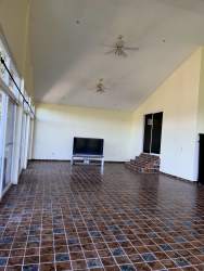 Living room mountain home vaulted ceilings large windows cream tile floor Altos del María Panama