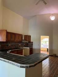 Kitchen with vaulted ceiling traditional wood finishes in mountain house Altos del María Panama