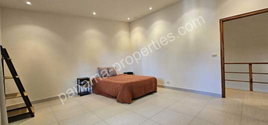 Kitchen with wood cabinetry, granite countertops, stainless appliances, window light Pedasi townhouse