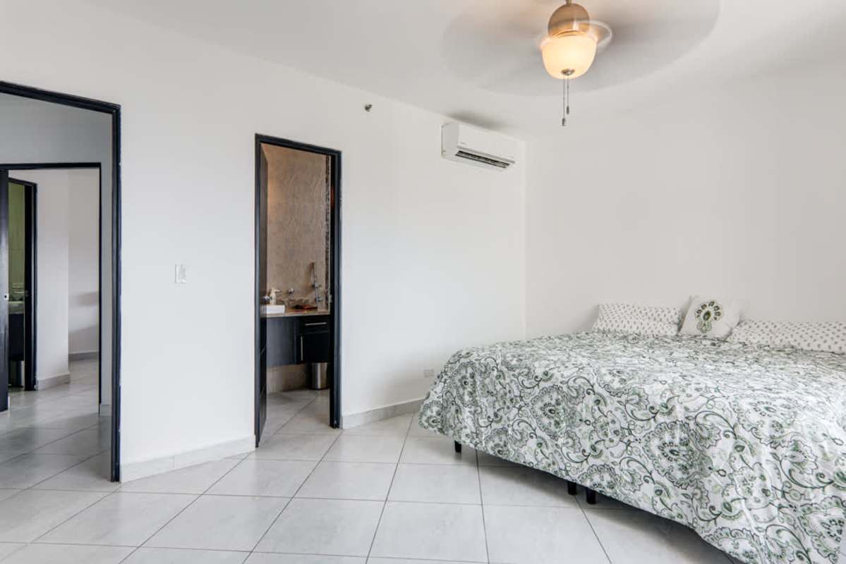 Spacious master bedroom with ensuite bathroom and skyline view Junior Penthouse El Cangrejo Panama