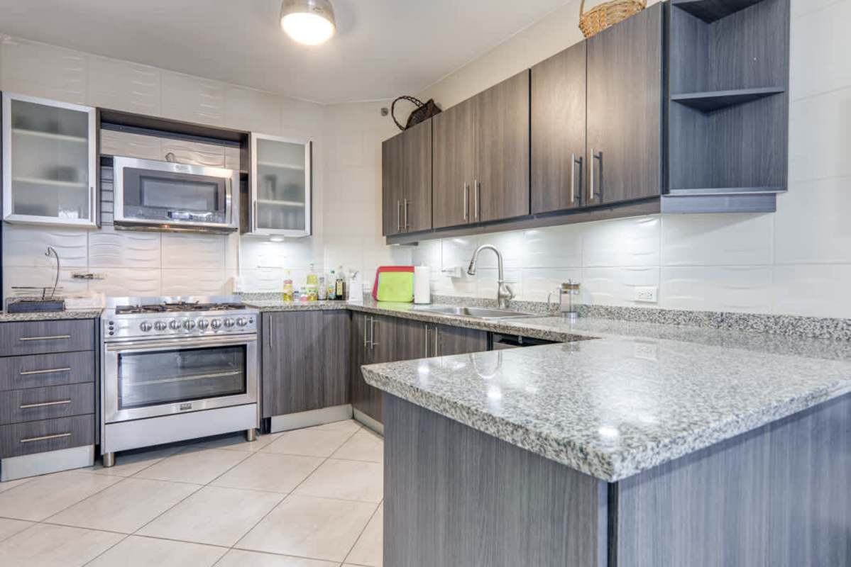 Fully-equipped modern kitchen with granite countertops and stainless steel appliances Junior Penthouse Luxor Tower Panama