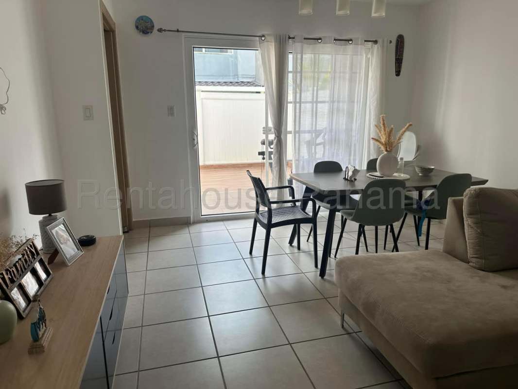 Ample living dining space with bright windows and terrace doorway in Victoria Brisas del Golf