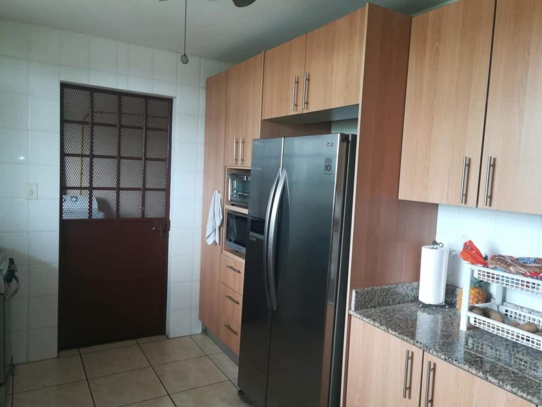 Bedroom minimalist with blue curtains, split AC, single bed and desk in remodeled home Brisas del Golf Panama