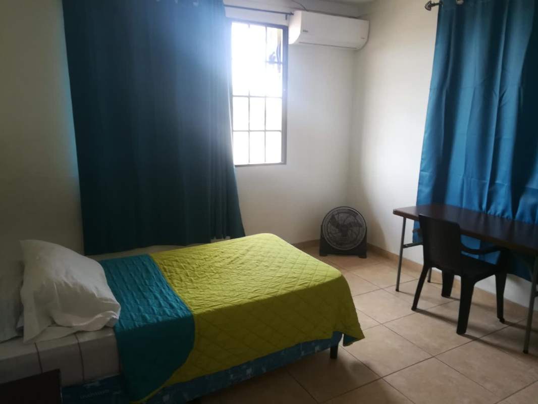 Simple bedroom with single bed curtains split AC renovated in Brisas del Golf Panama