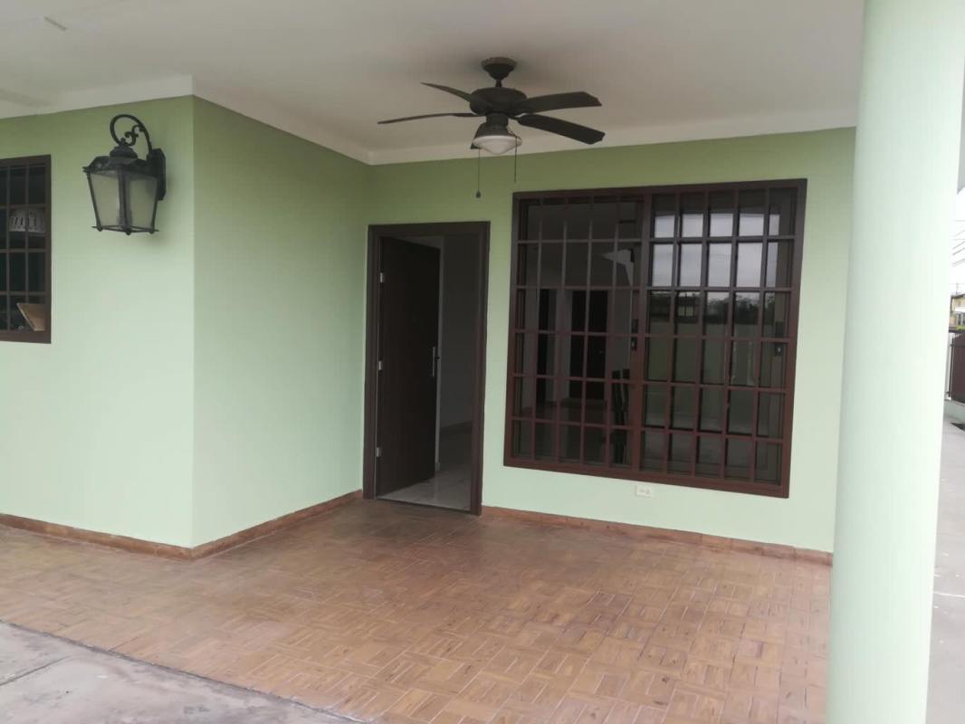 Covered terrace with tiled floor, fan, large window in Brisas del Golf Panama house