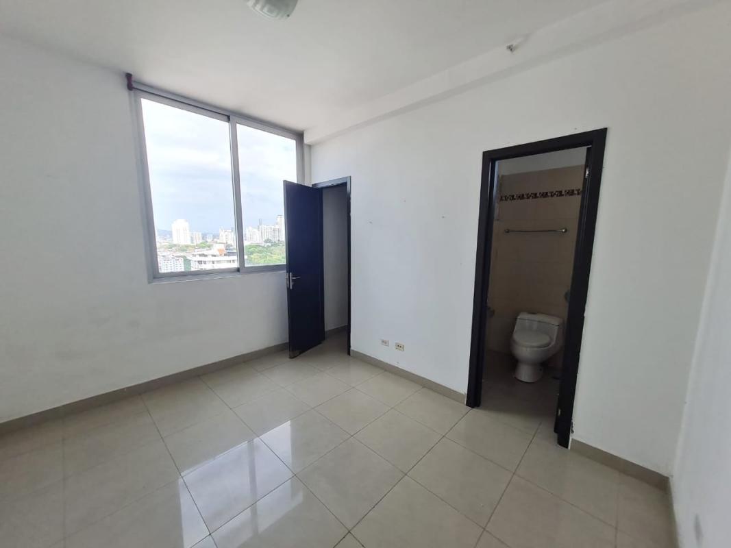 Empty apartment living room with neutral ceramic tiles, white walls, spacious layout in PH Latorraca Panama City