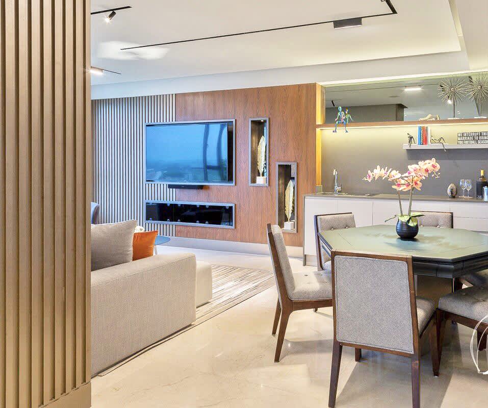 Open plan luxury living dining with wood accents TV wall at Santa Maria Panama