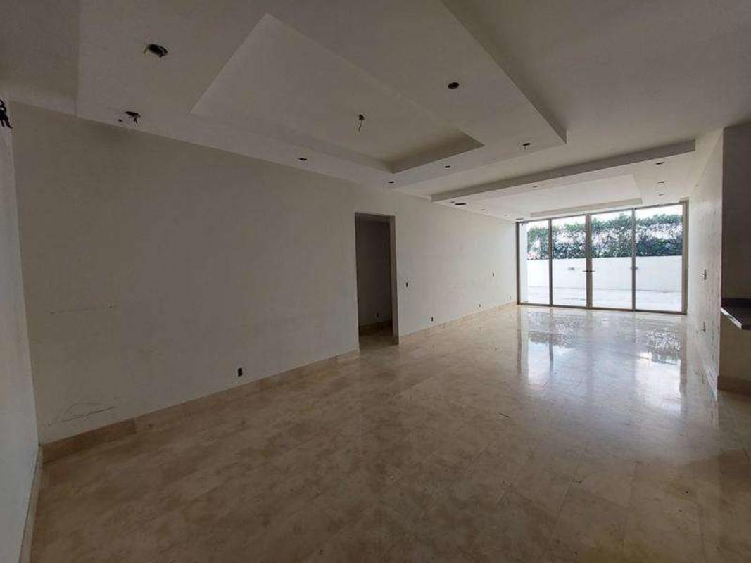 Spacious living room with marble floors and floor-to-ceiling glass doors PH Greenview Panama