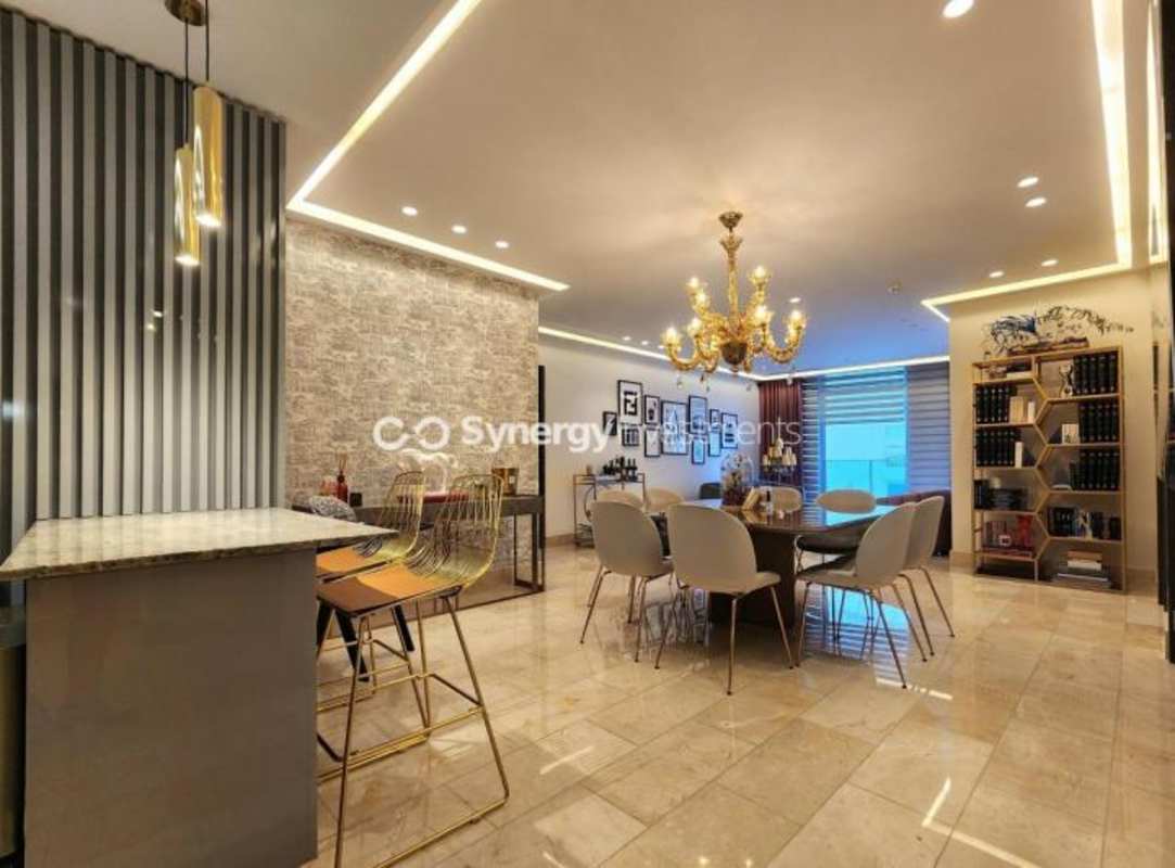 Modern dining area with island kitchen, pendant lights in PH Ocean Riviera Punta Pacifica