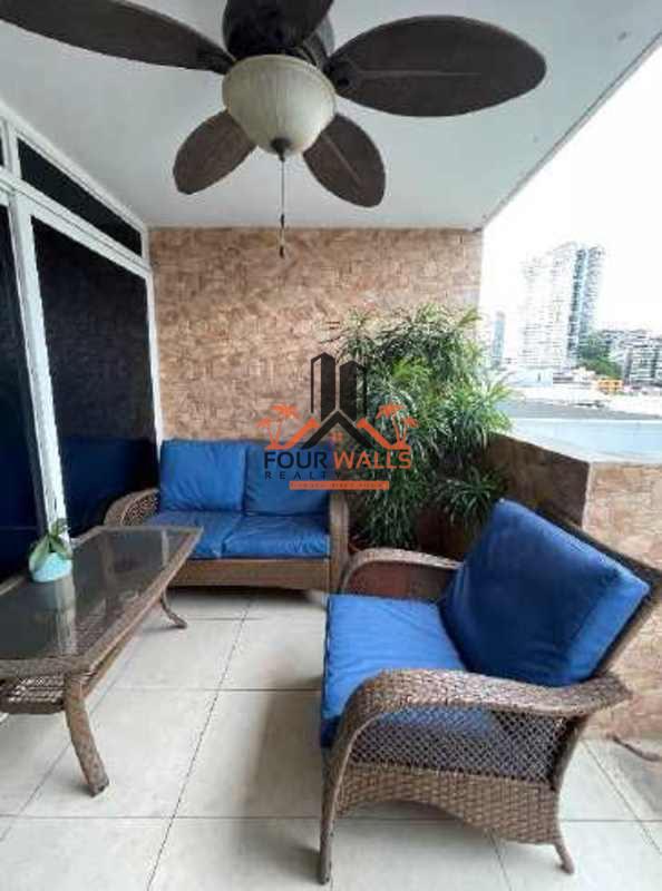 Balcony with rattan outdoor furniture, ceiling fan, and city view in apartment PH Blue Park Bella Vista