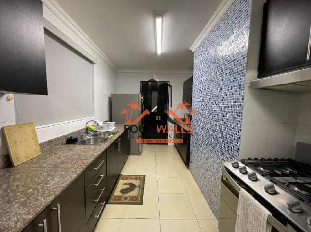 Modern galley kitchen with mosaic tile backsplash, granite counters and appliances at PH Blue Park