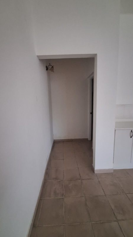 Hallway with tile floor light walls inside Metro Park View office Panama
