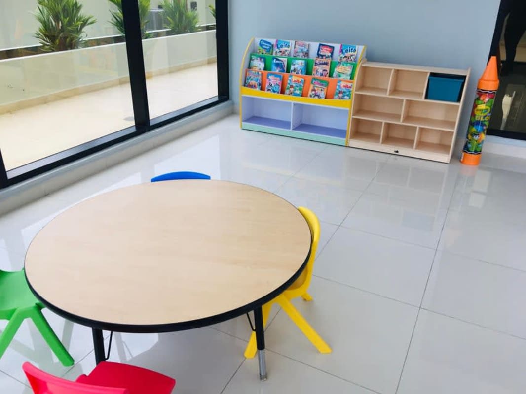 Colorful kids playroom with toys, tables and large windows at PH Luxor Tower Obarrio